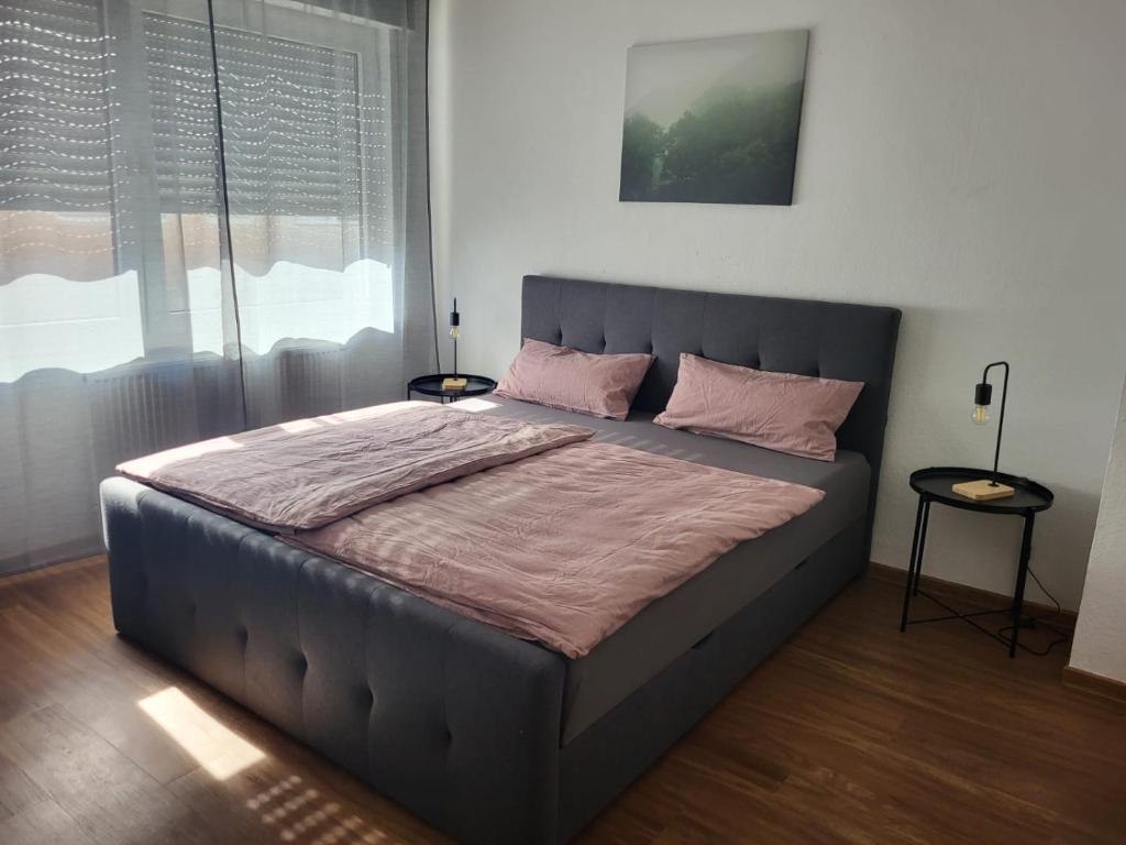 a bedroom with a large bed with pink pillows at C&V 4 Personen 3 Zimmer Central Smart TV Boxspringbett in Kaiserslautern