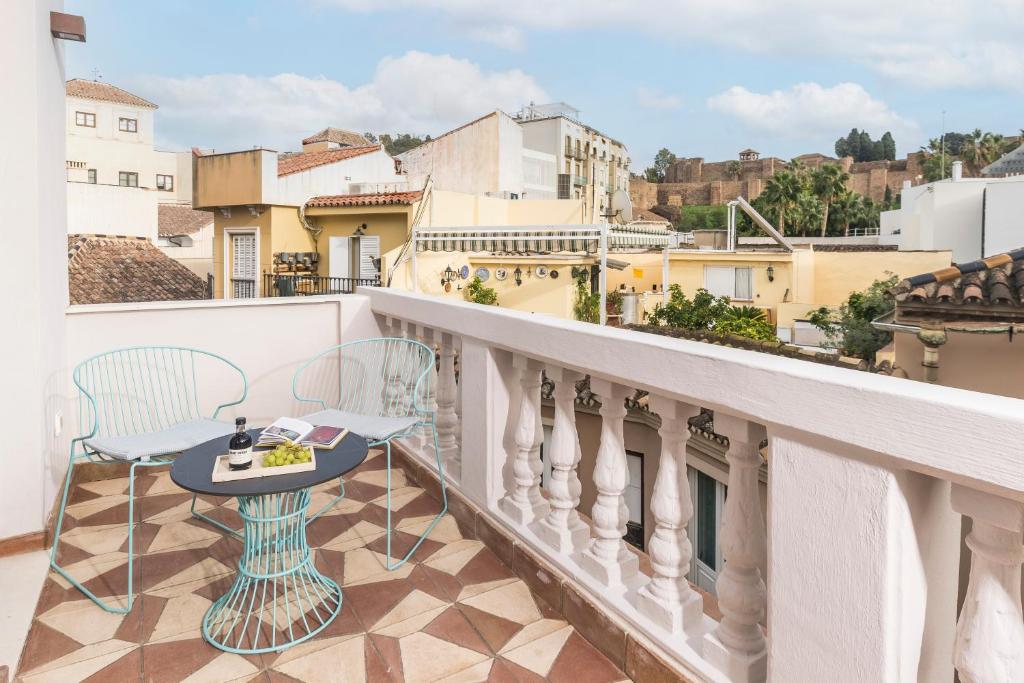 a balcony with a table and chairs and a view at Picasso III in Málaga