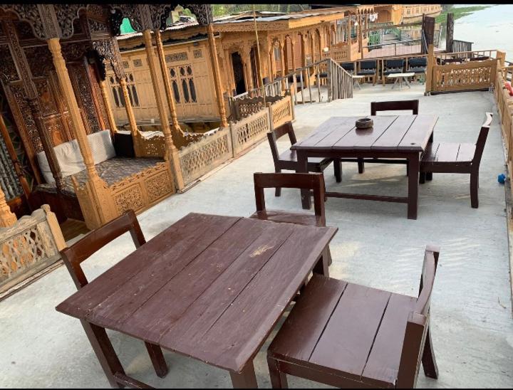 a group of tables and chairs on a patio at BAKTOO palace PREMIUM HOUSEBOAT in Srinagar