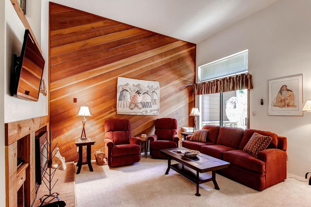 a living room with a couch and two chairs at Winter Point 22 in Breckenridge