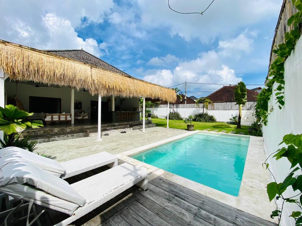 a villa with a swimming pool and a patio at Villa Stari in Canggu