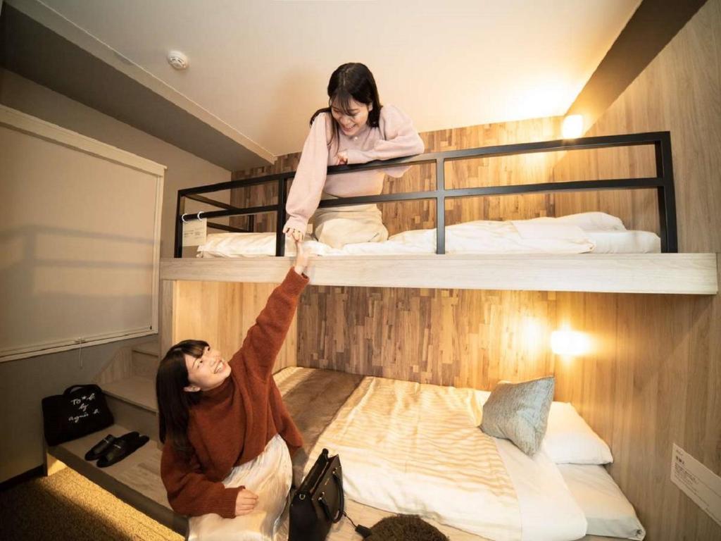 Postel nebo postele na pokoji v ubytování Super Hotel Premier Namba Shinsaibashi Natural Hot Spring