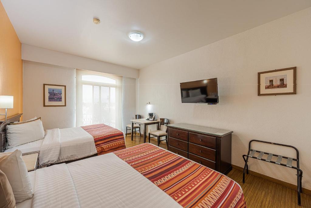 Postel nebo postele na pokoji v ubytování HG Hotel