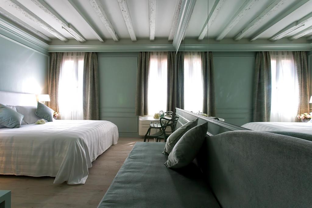 Postel nebo postele na pokoji v ubytování Aquamare, boutique b&b