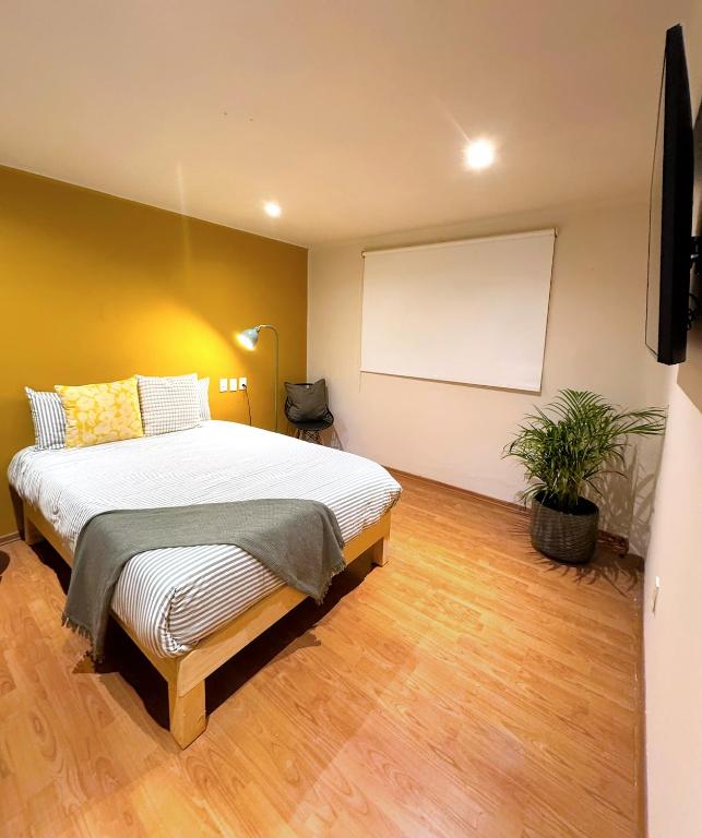 a bedroom with a large bed and a whiteboard at Private room La Americana Chapultepec in Guadalajara