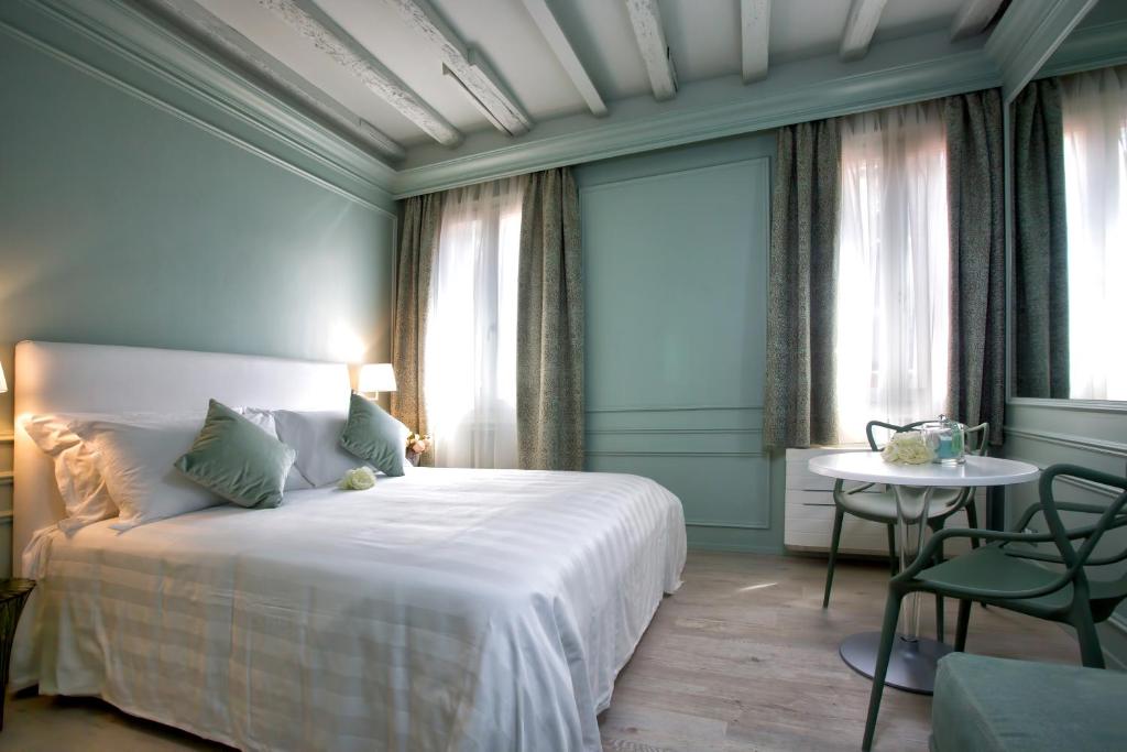 Postel nebo postele na pokoji v ubytování Aquamare, boutique b&b