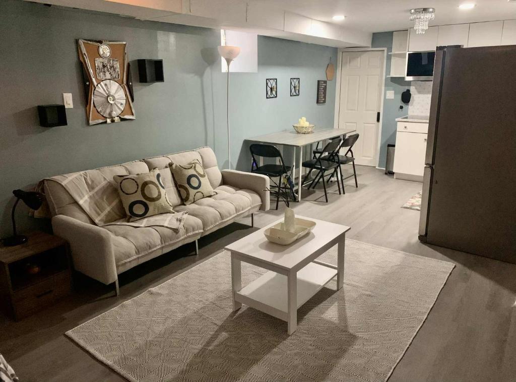 a living room with a couch and a table at Suhira Hospitality in Lansdowne