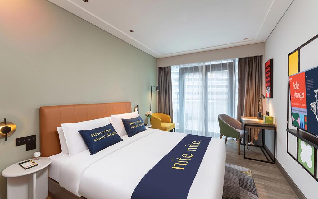 Postel nebo postele na pokoji v ubytování The Mustel Hotel Chongqing Hongyadong