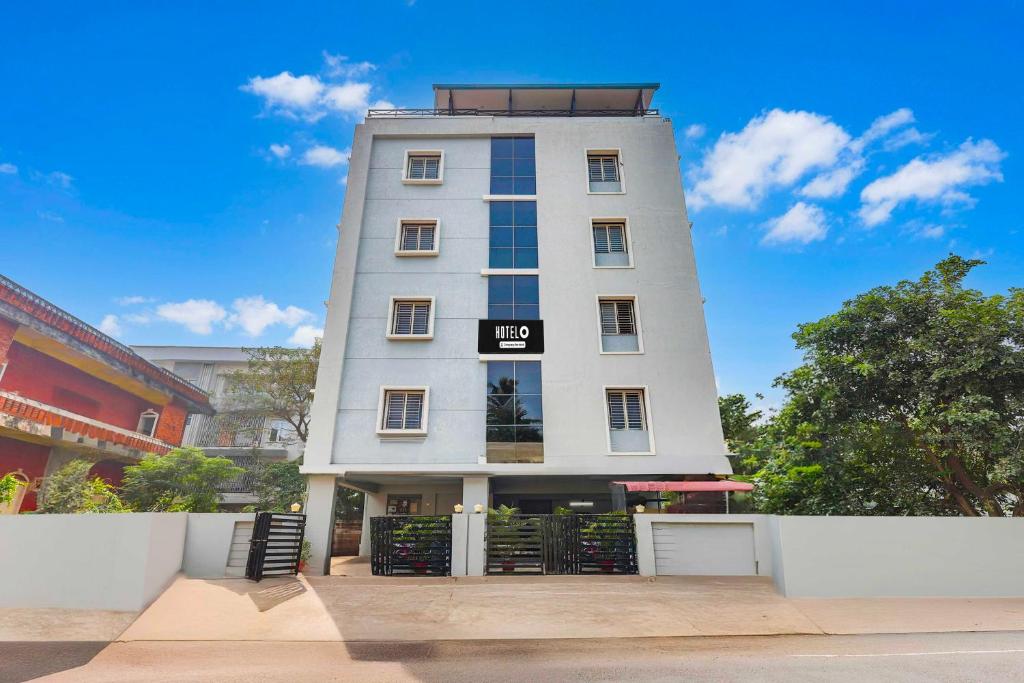 a tall white building with a sign on it at Townhouse Kakinada Town Junction in Kākināda