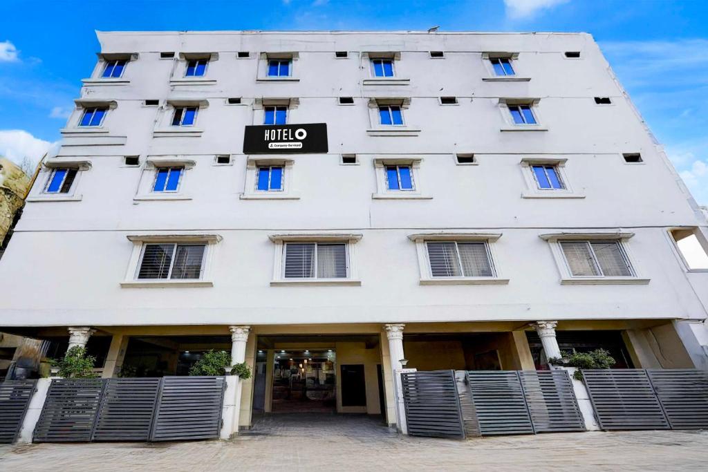 a white building with a sign on it at Hotel O Tirumala Road Near Alipiri in Tirupati
