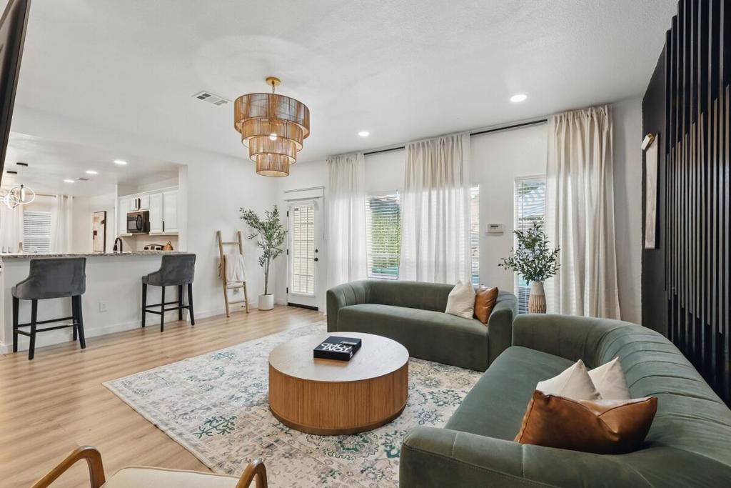 a living room with a couch and a table at The Beach Oasis In Dallas, Pool & Sauna in Plano