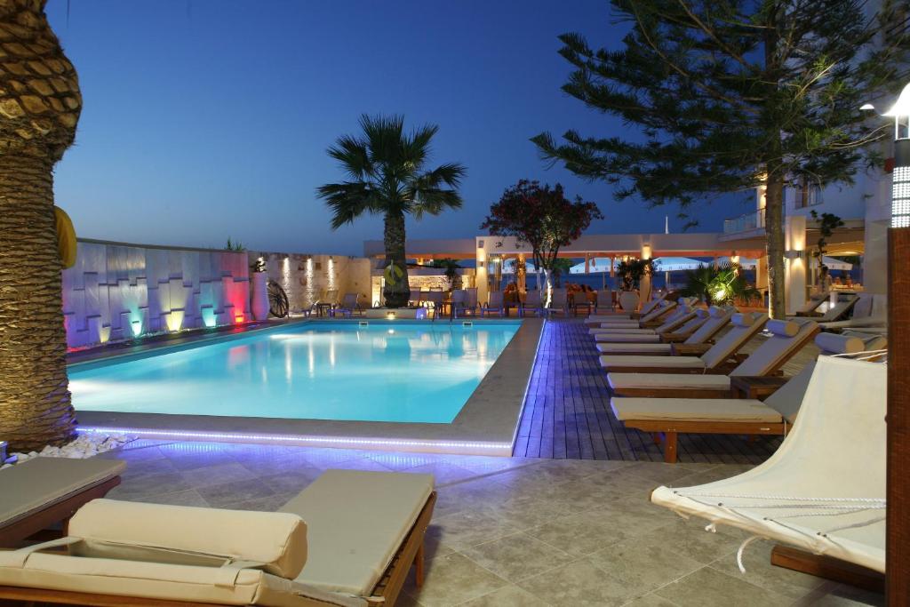 a swimming pool with lounge chairs and a hotel at Glaros Beach Hotel in Hersonissos