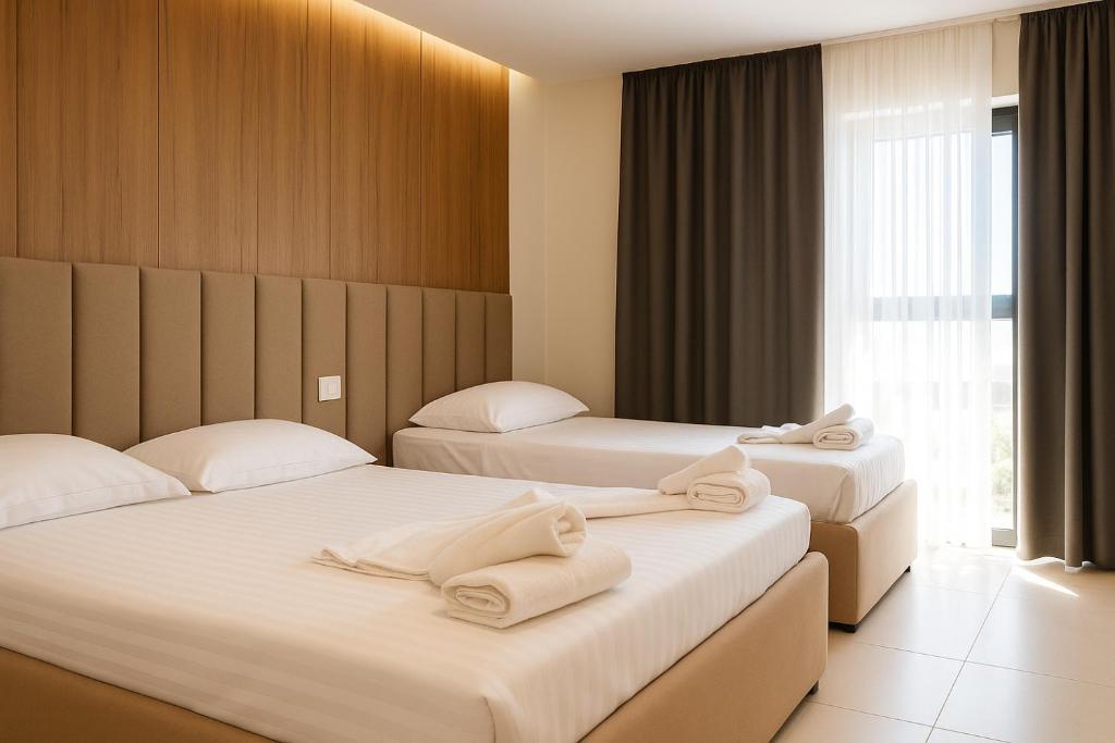Postel nebo postele na pokoji v ubytování Velmar Hotel