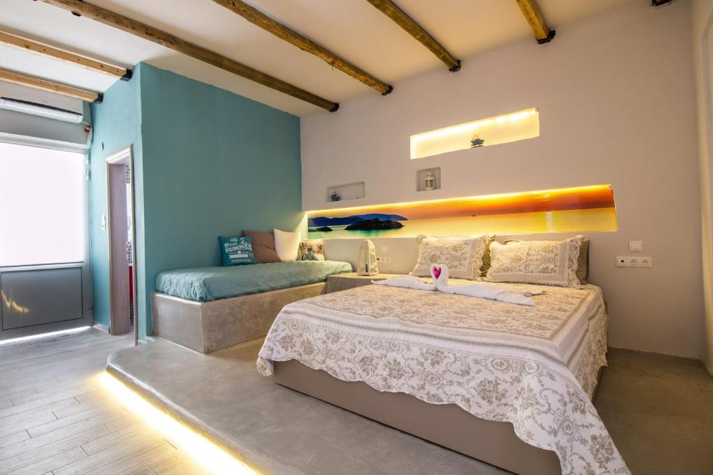 a bedroom with a large bed and a couch at Kastri Beach in Faliraki