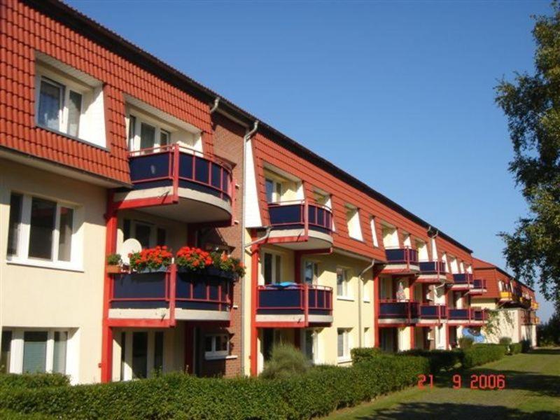 a building with flower boxes on the balconies of it at Appartementhaus Residenz Duenengarten in Kühlungsborn