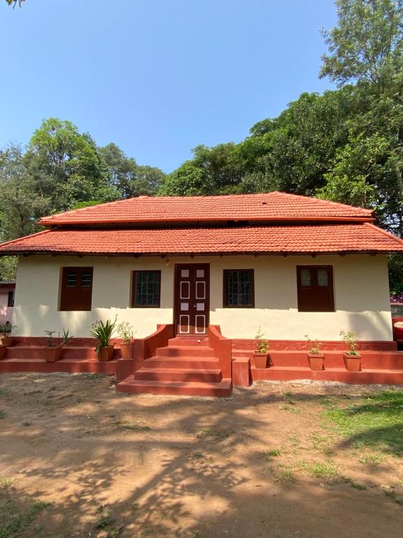 a small house with a red roof at Dreamland Vintage Homestay in Jambur