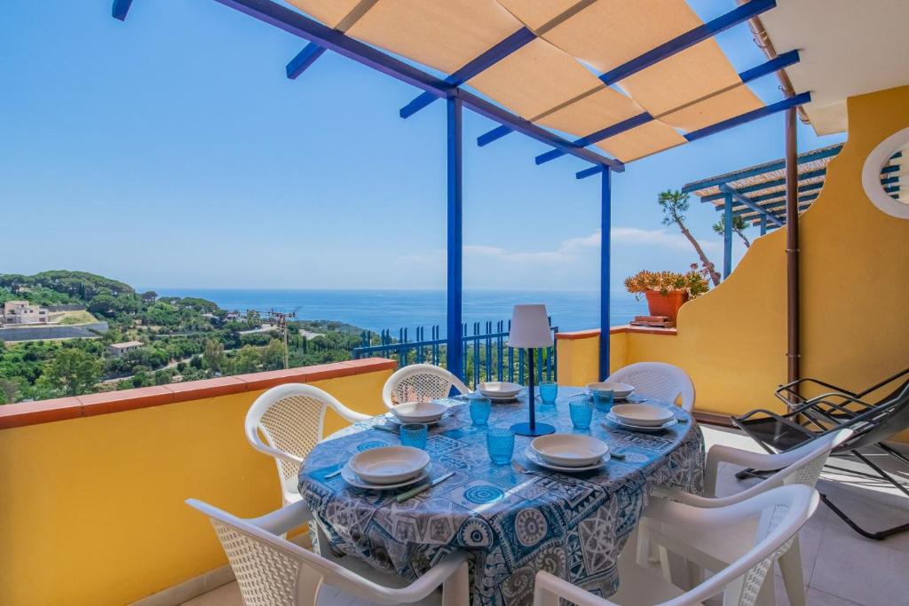 a table and chairs on the balcony of a house at Bel Horizonte 6 in Capoliveri