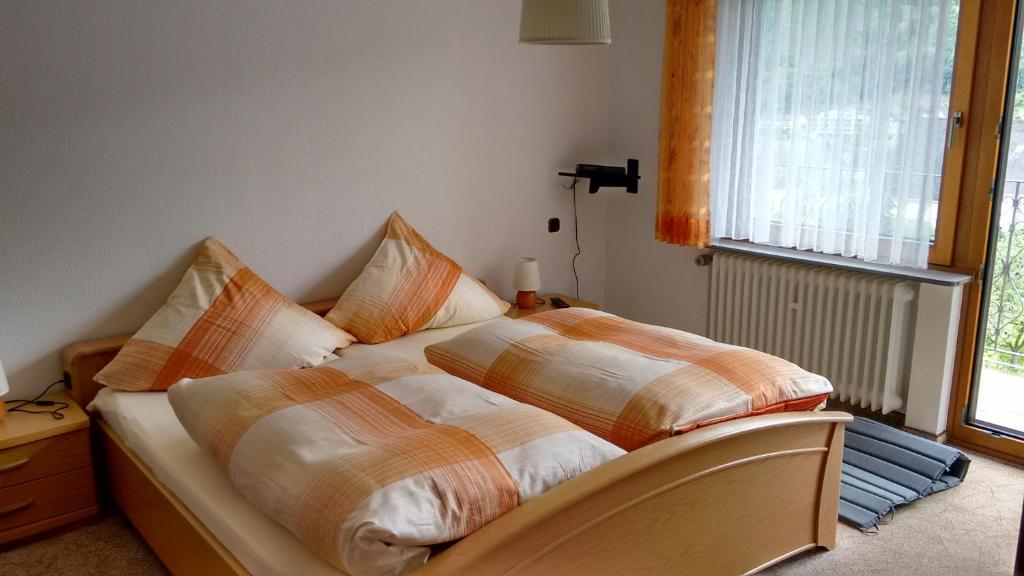 a bed with two pillows on it in a bedroom at Gästehaus Kiesgen-Mendgen in Bernkastel-Kues