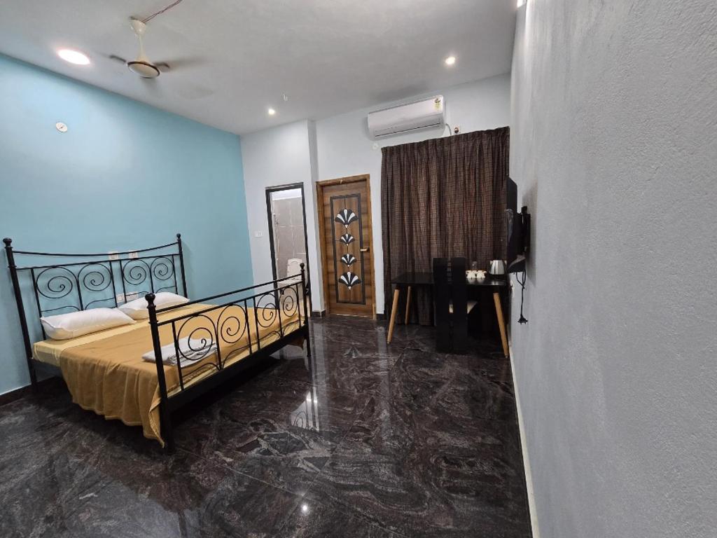 a bedroom with a bed in a room with blue walls at perumal home stay in Tiruvannāmalai