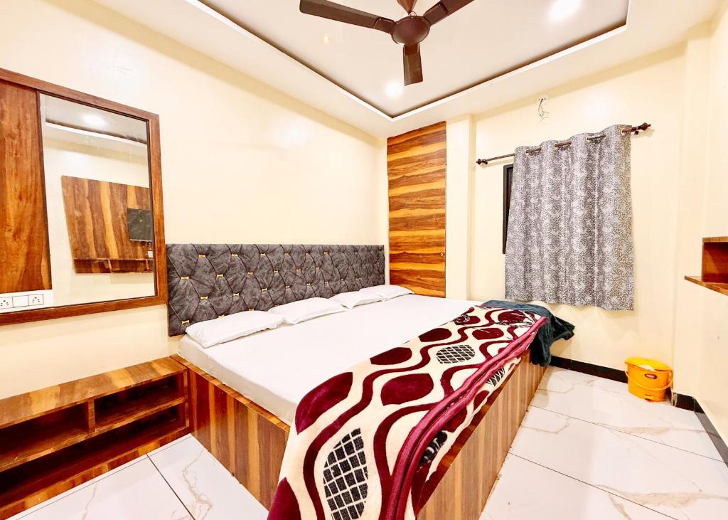 a bedroom with a bed and a window at Near Mahakal Temple # Hotel D-e-m-a-n-d ! ujjain, All Room Air conditioned And Spacious, with Wifi -BEST HOTEL IN UJJAIN in Ujjain