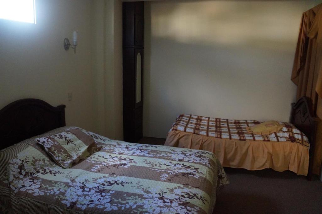 Postel nebo postele na pokoji v ubytování Hostal Pucará