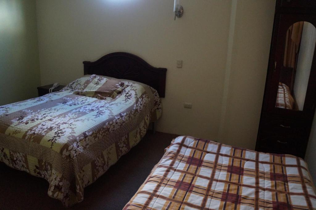 Postel nebo postele na pokoji v ubytování Hostal Pucará