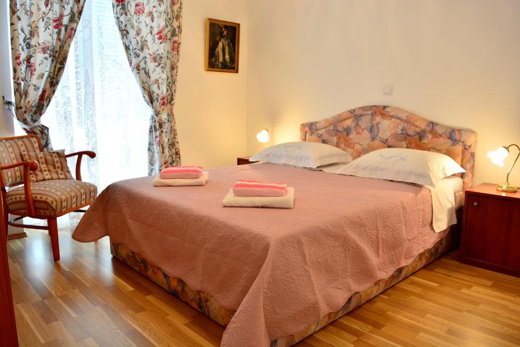 a bedroom with a bed with two towels on it at Apartments M&B in Podstrana