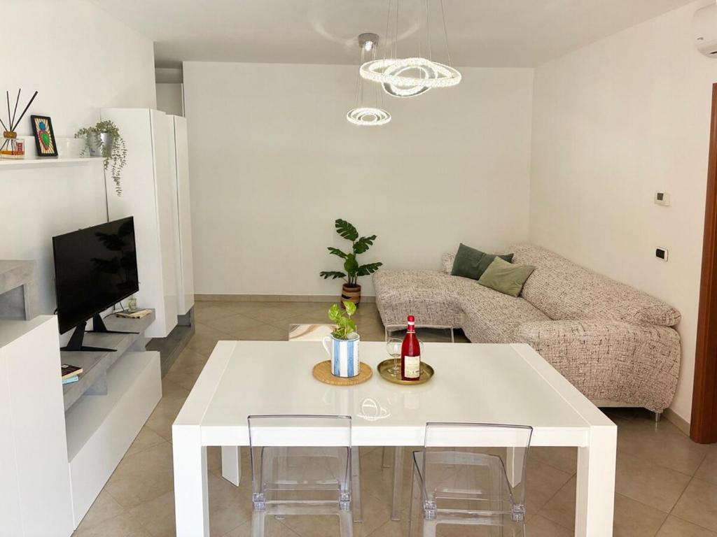 a living room with a white table and a couch at Holihome Mondo Serena in Tortoreto Lido