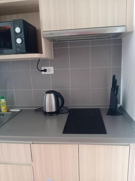 a kitchen with a tea kettle on the counter at Home hugs in Bangna