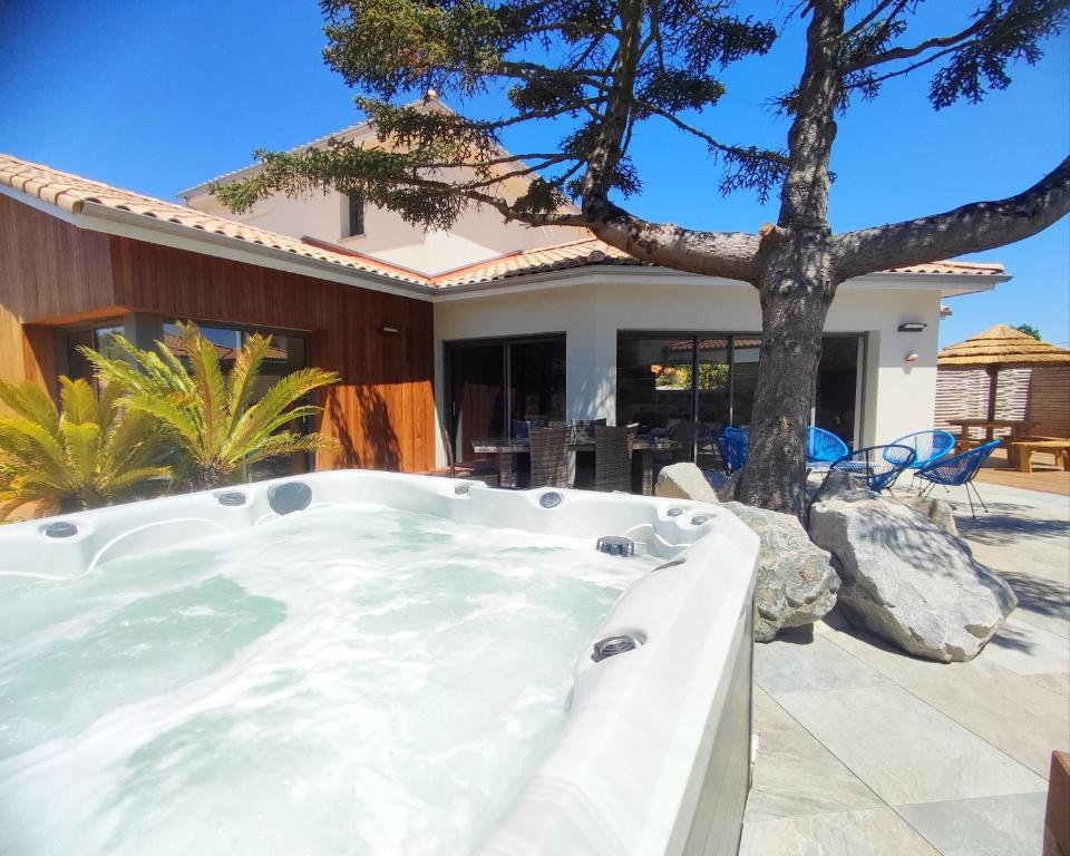 a hot tub in the backyard of a house at Villa et Spa in Pornic