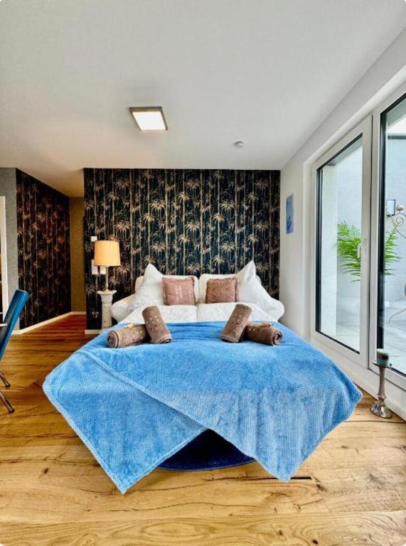 a bedroom with a large bed with a blue blanket at Luxury Long-Term Apartment with Terrace in Vienna