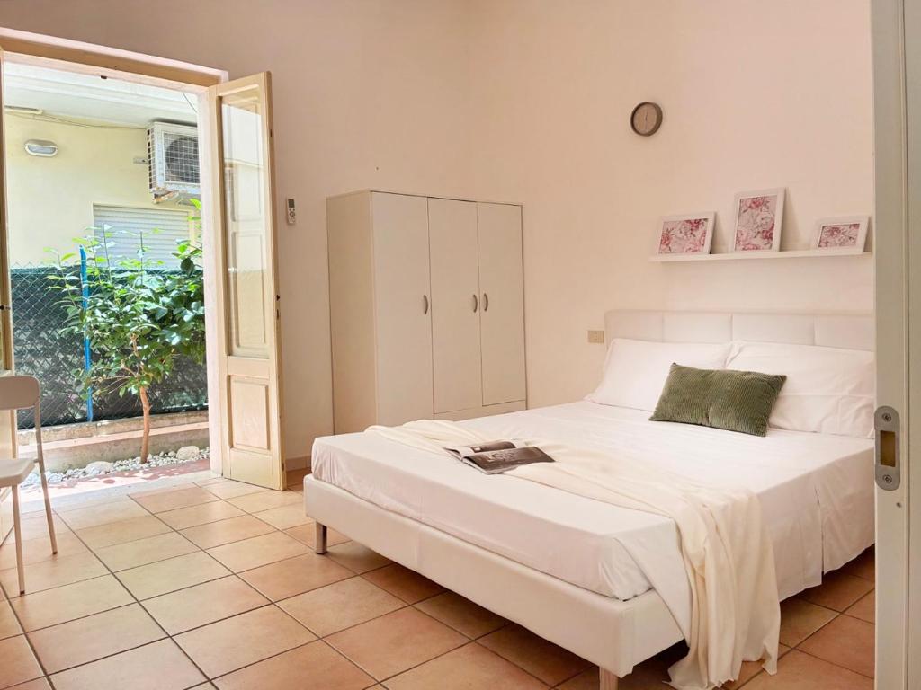 a bedroom with a large white bed and a window at Holihome Room Eight in Tortoreto Lido