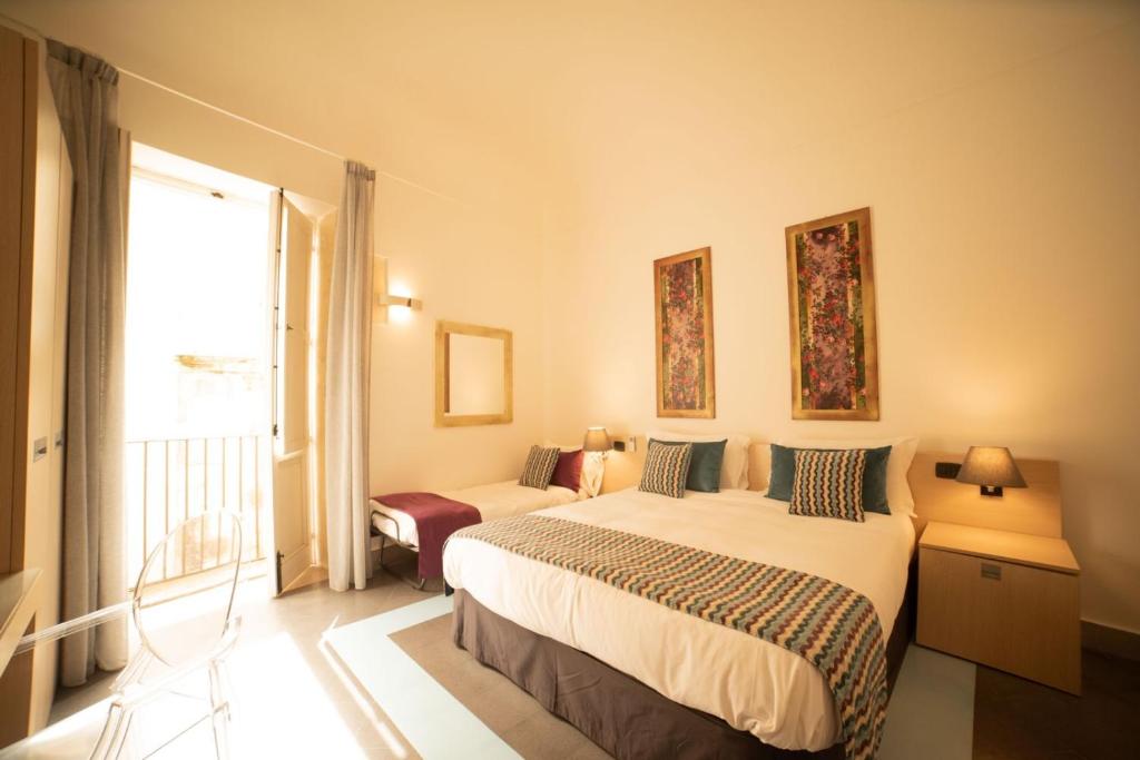 Postel nebo postele na pokoji v ubytování Archimede Vacanze B&B