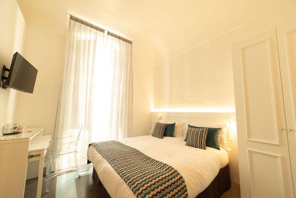 Postel nebo postele na pokoji v ubytování Archimede Vacanze B&B