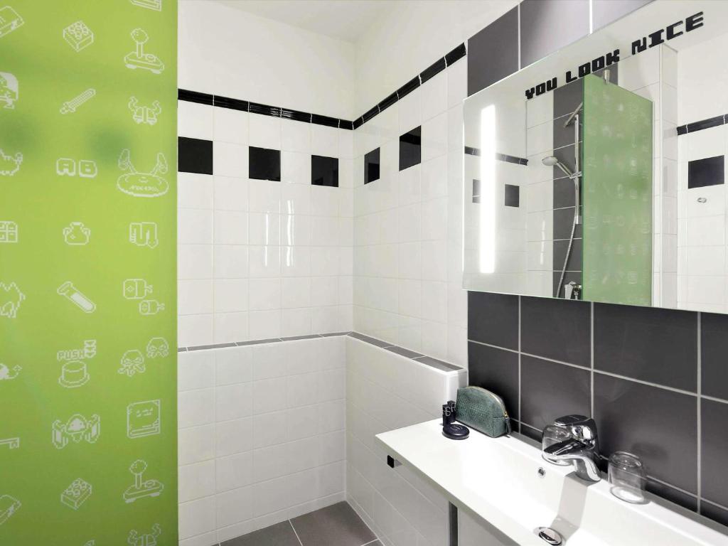a bathroom with a sink and a mirror at Ibis Styles Budapest Center in Budapest