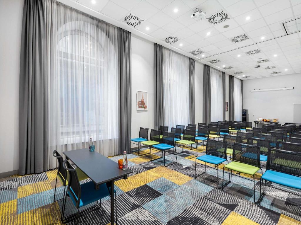 a classroom with tables and chairs in a room at Ibis Styles Budapest Center in Budapest