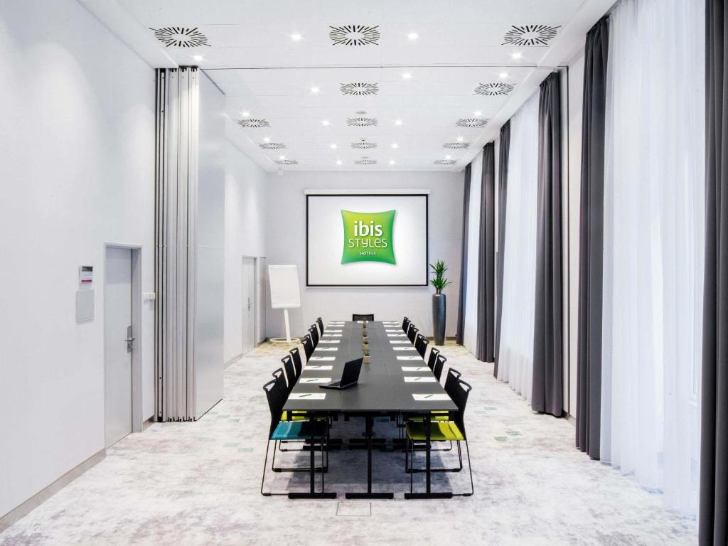 a long conference room with a long table and chairs at Ibis Styles Budapest Center in Budapest