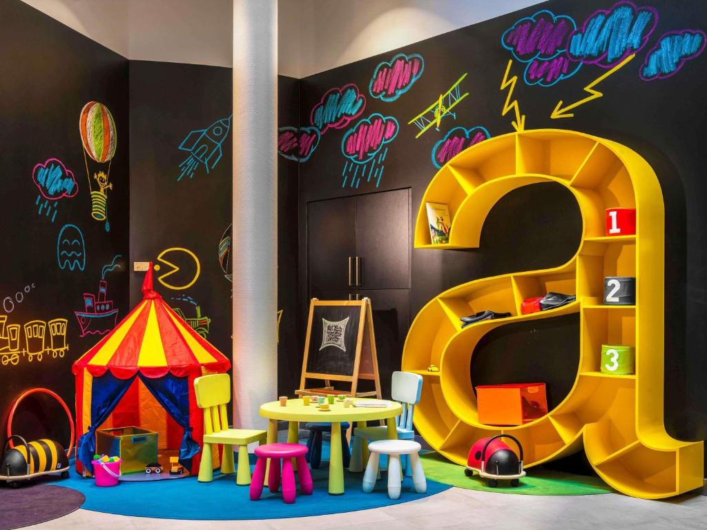 a play room with a play structure and a play tent at Ibis Styles Budapest Center in Budapest