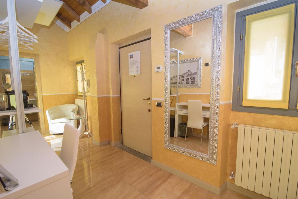 a dining room with a mirror and a table at Appartamenti S Onofrio Rho in Rho
