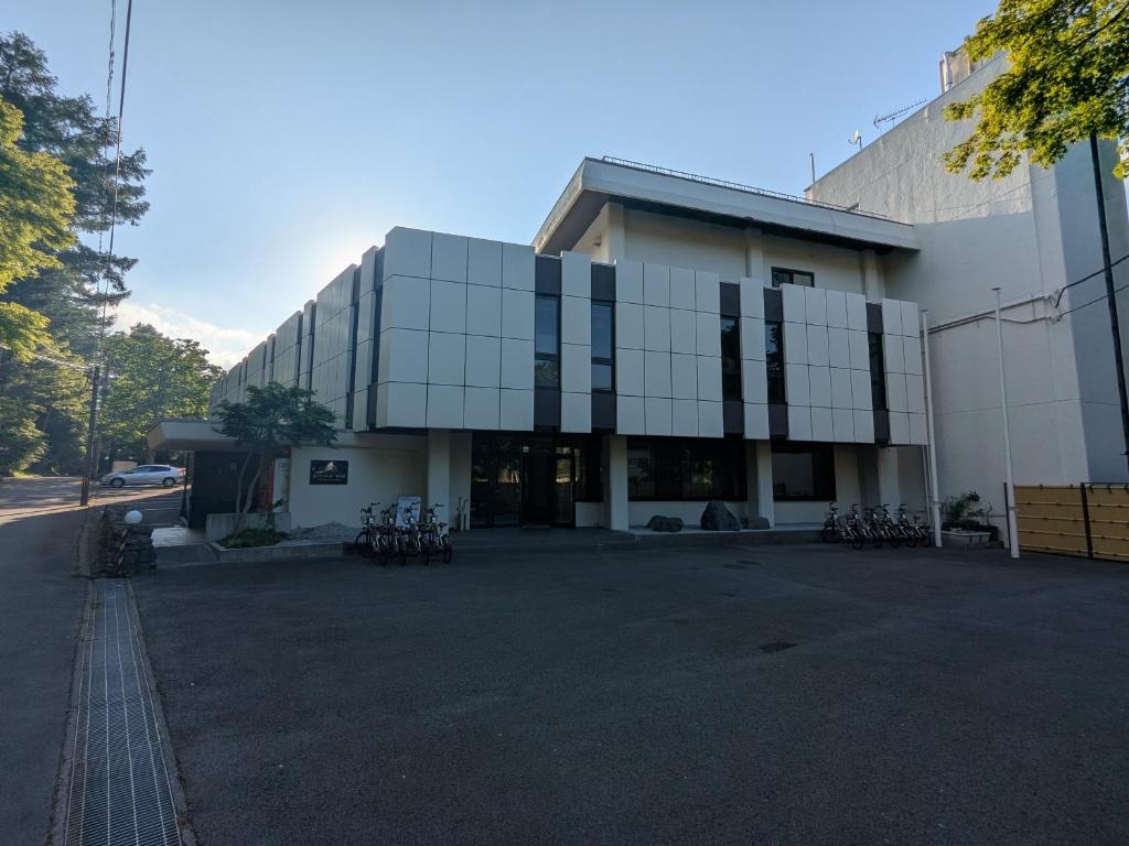 a large glass building with bikes parked outside of it at 富士たから荘 旭日館 in Yamanakako