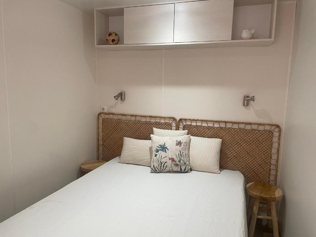 a small bedroom with a bed with white sheets at Chiclavie in La Celle-sous-Gouzon