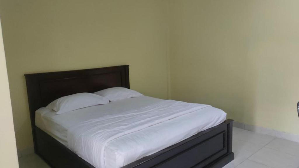 Ένα ή περισσότερα κρεβάτια σε δωμάτιο στο Nangas Homestay