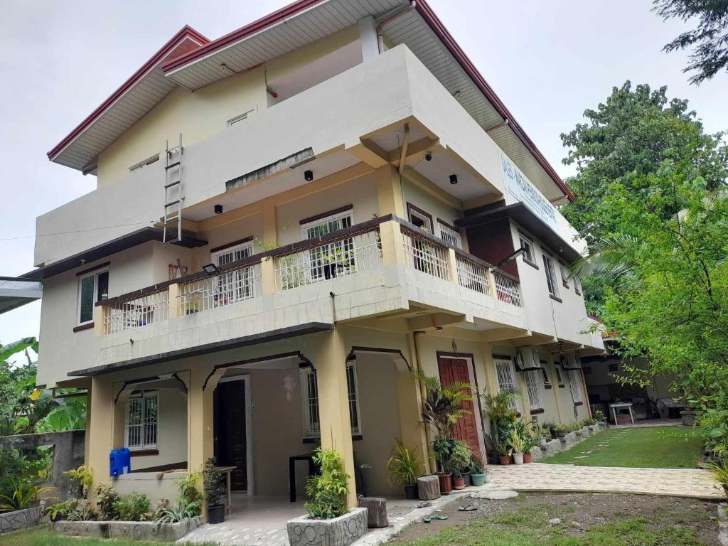 a building with a balcony on the side of it at Sales-Marzan Pension House Rental in Aringay