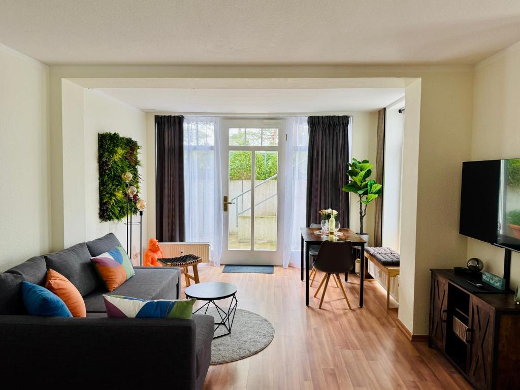 a living room with a couch and a table at Strandstudio 19, Exklusive Wohnung, erste Reihe, Strand, Kamin in Binz