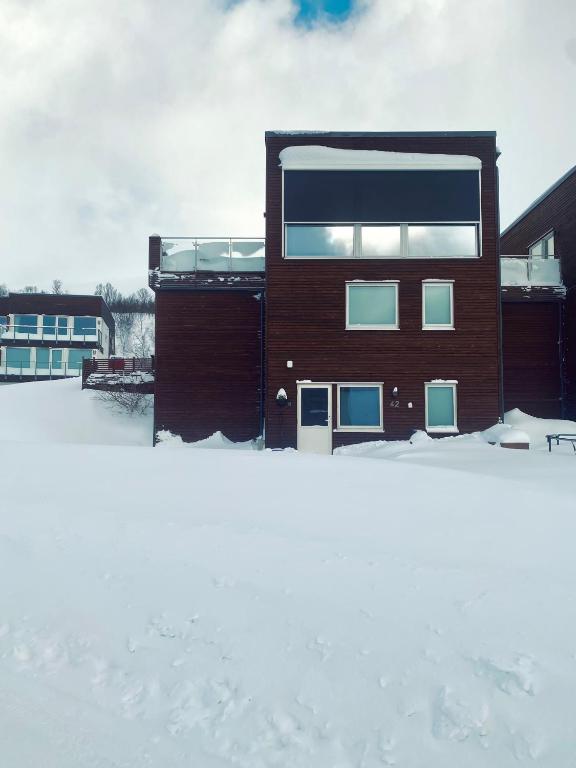 a building with snow in front of it at Leilighet i Tromsø in Tromsø