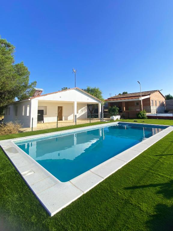a swimming pool in the yard of a house at Villa Alarilla Grupos Grandes in Fuentidueña de Tajo
