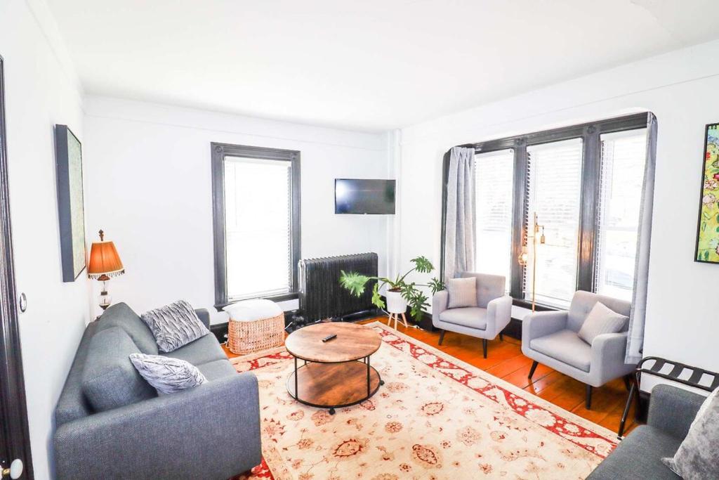 a living room with a couch and two chairs and a table at Centrally located East End & off-street parking in Portland