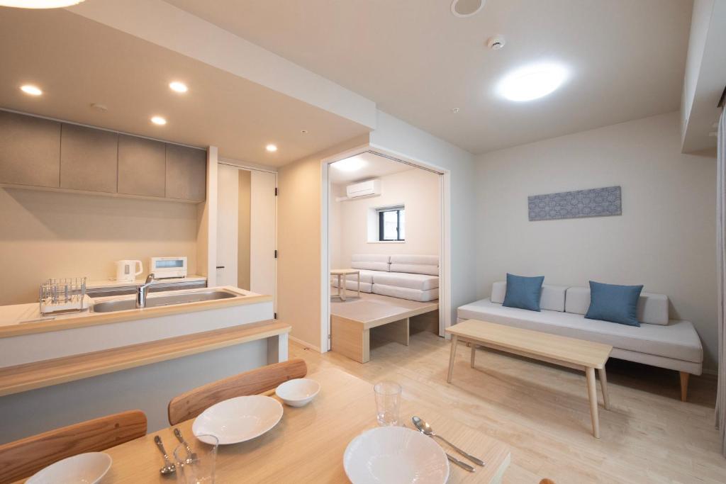 a kitchen and living room with a table and a couch at THE RISE Osaka Universal Bayside in Osaka