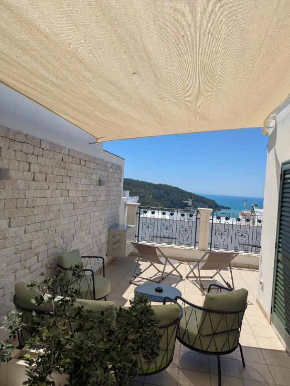 a patio with a table and chairs on a balcony at Al Corso Charming Rooms in Peschici