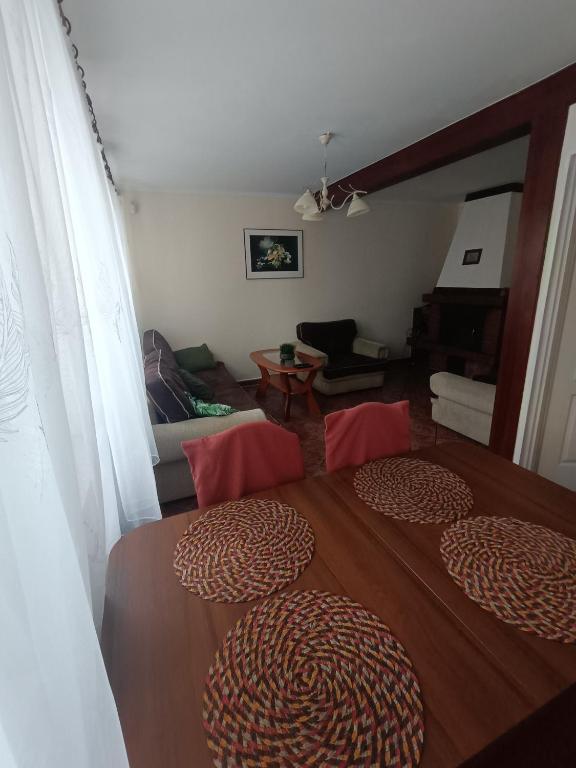 a bedroom with a bed and a living room at Apartament I in Rowy